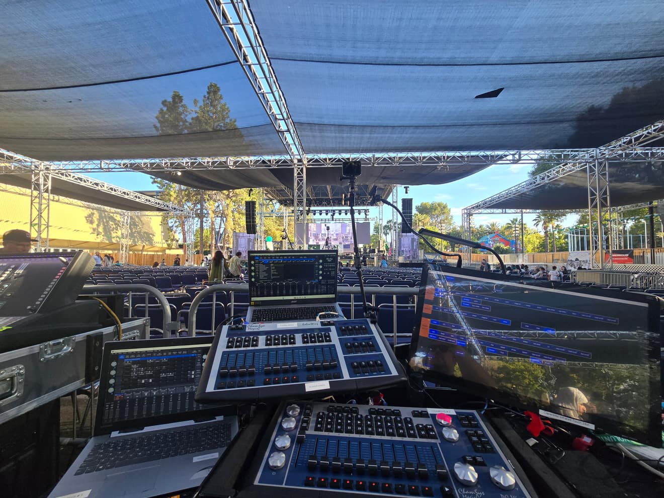 Two lighting consoles and laptops at front of house, programming the show before doors