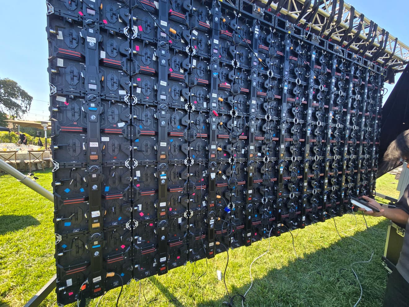 LED wall panels going up on the truss, cable run and labeled, during rig-up