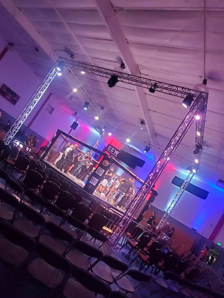 Support towers and lighting rig built over an indoor arena floor