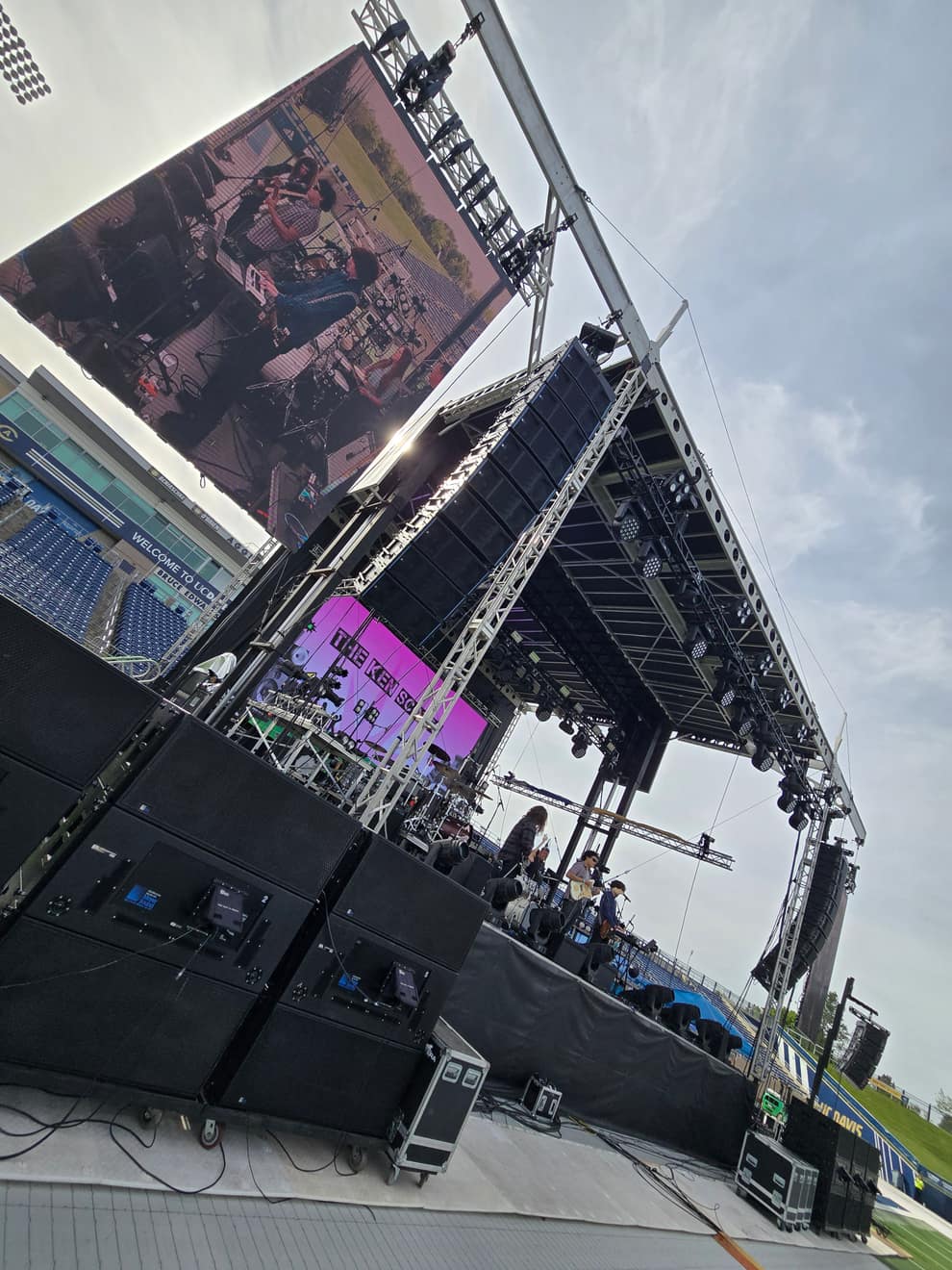 LED video wall and side screens seen from the rigging, stadium crowd below