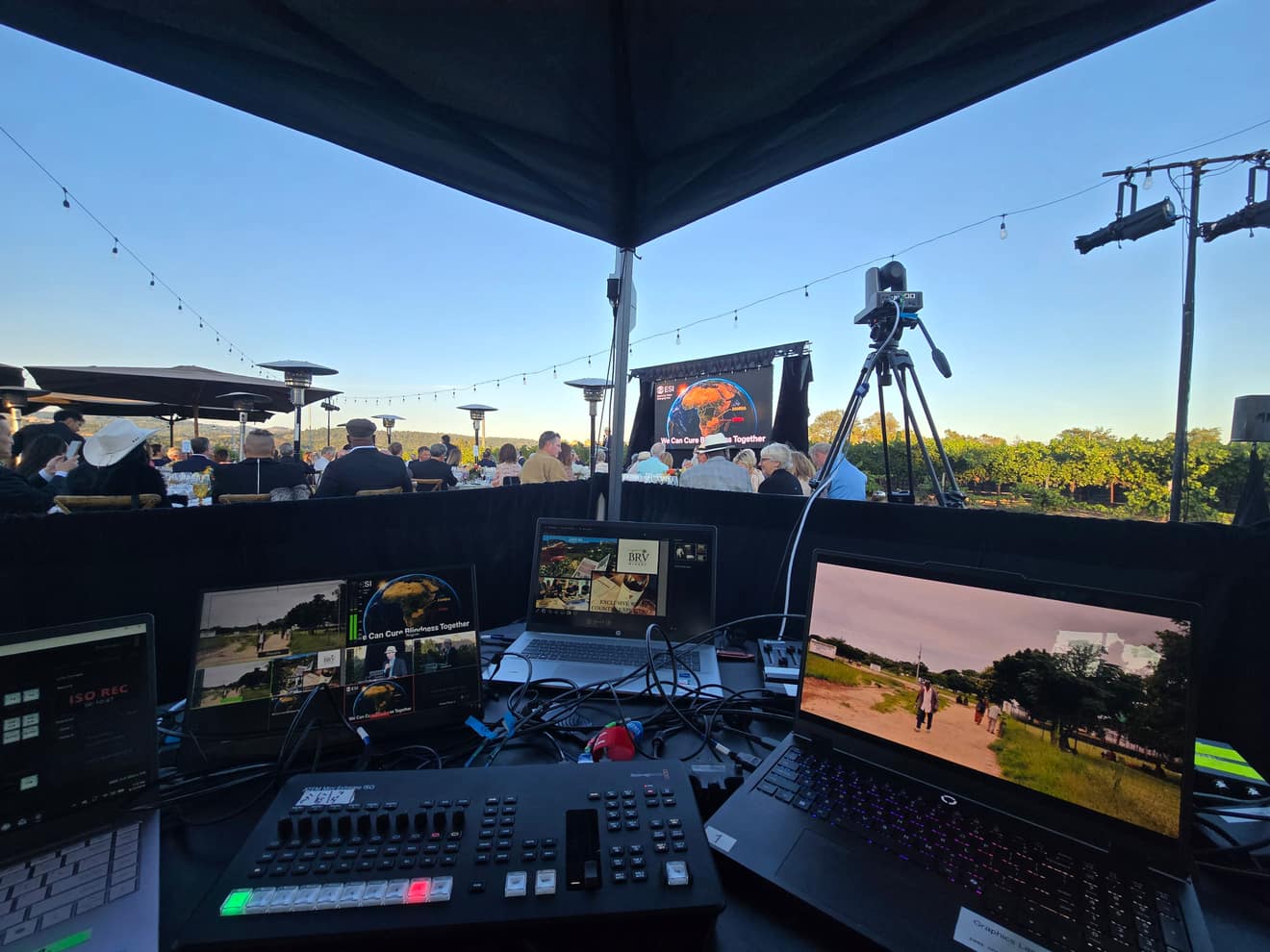 Camera and monitor tent at sunset, cutting the live feed to the screen